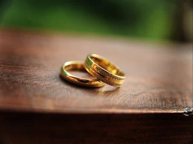 wedding rings on top of each other on table